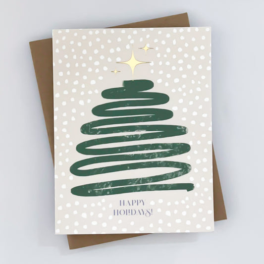 A holiday card featuring a hand-drawn green Christmas tree with white polka dots and a gold foil star on top, along with the text 'Happy Holidays' 