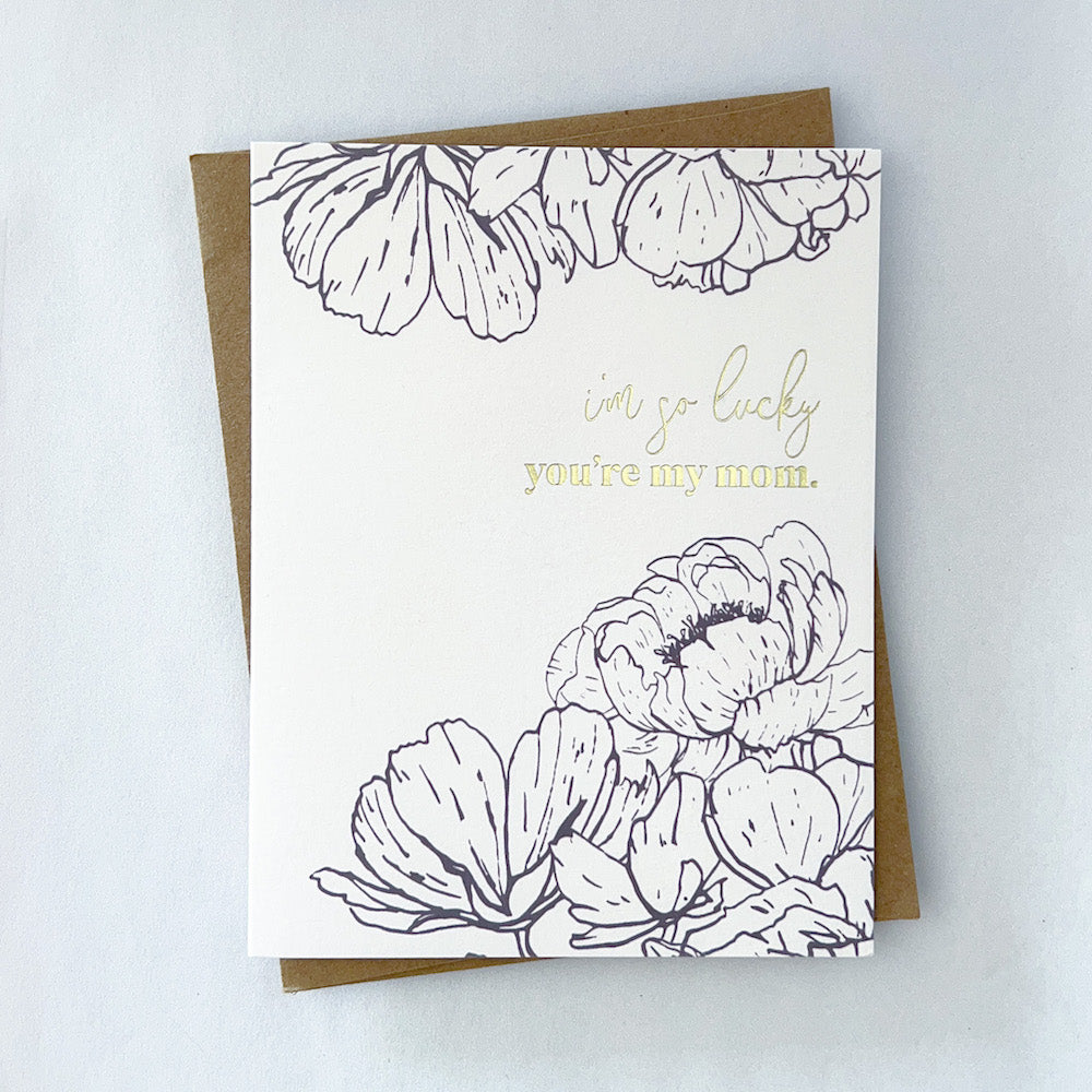 A mothers day card with black florals framing gold foil text that reads 'I'm so lucky you're my mom'