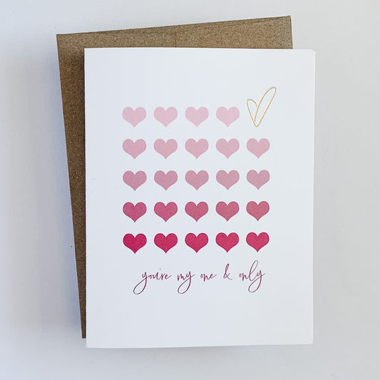A card with ombre pink hearts with a gold foil heart. The text reads 'you're my one and only'