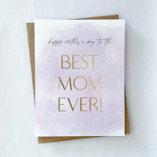 A mothers day card with a light purple wash that reads 'happy mothers day to the' and in gold foil text 'best mom ever'