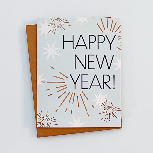 A Happy New Year card with copper foil accents, along with star and sparkle designs. The text reads 'Happy New Year!'.