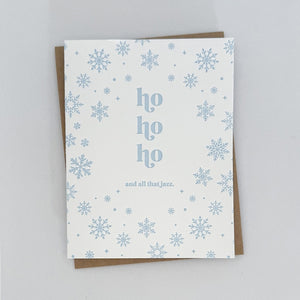 A Holiday Card with a white background featuring light blue snowflakes surrounding text that reads 'ho ho ho and all that jazz'