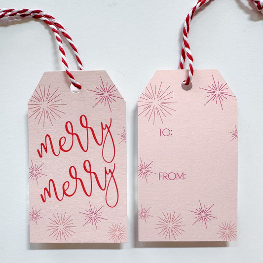 Pink gift tag with red star beam accents and red text that reads 'merry merry' With to and from on the back 